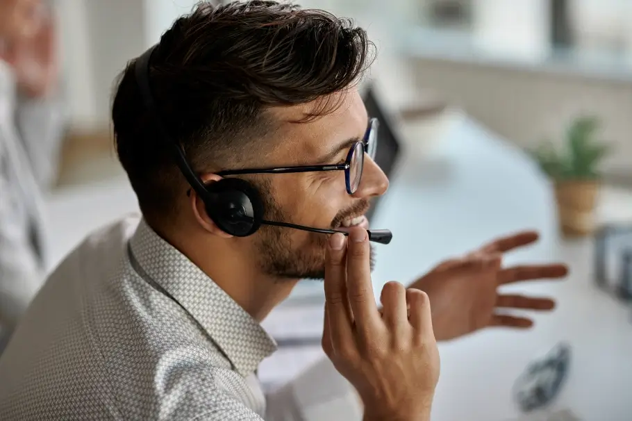 a consultant speaking to a student on with his headset on