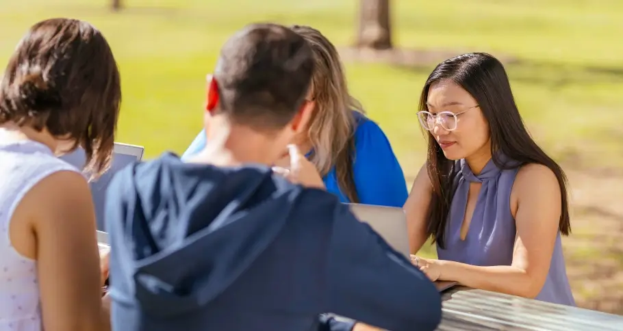 a group of student discussing at a park